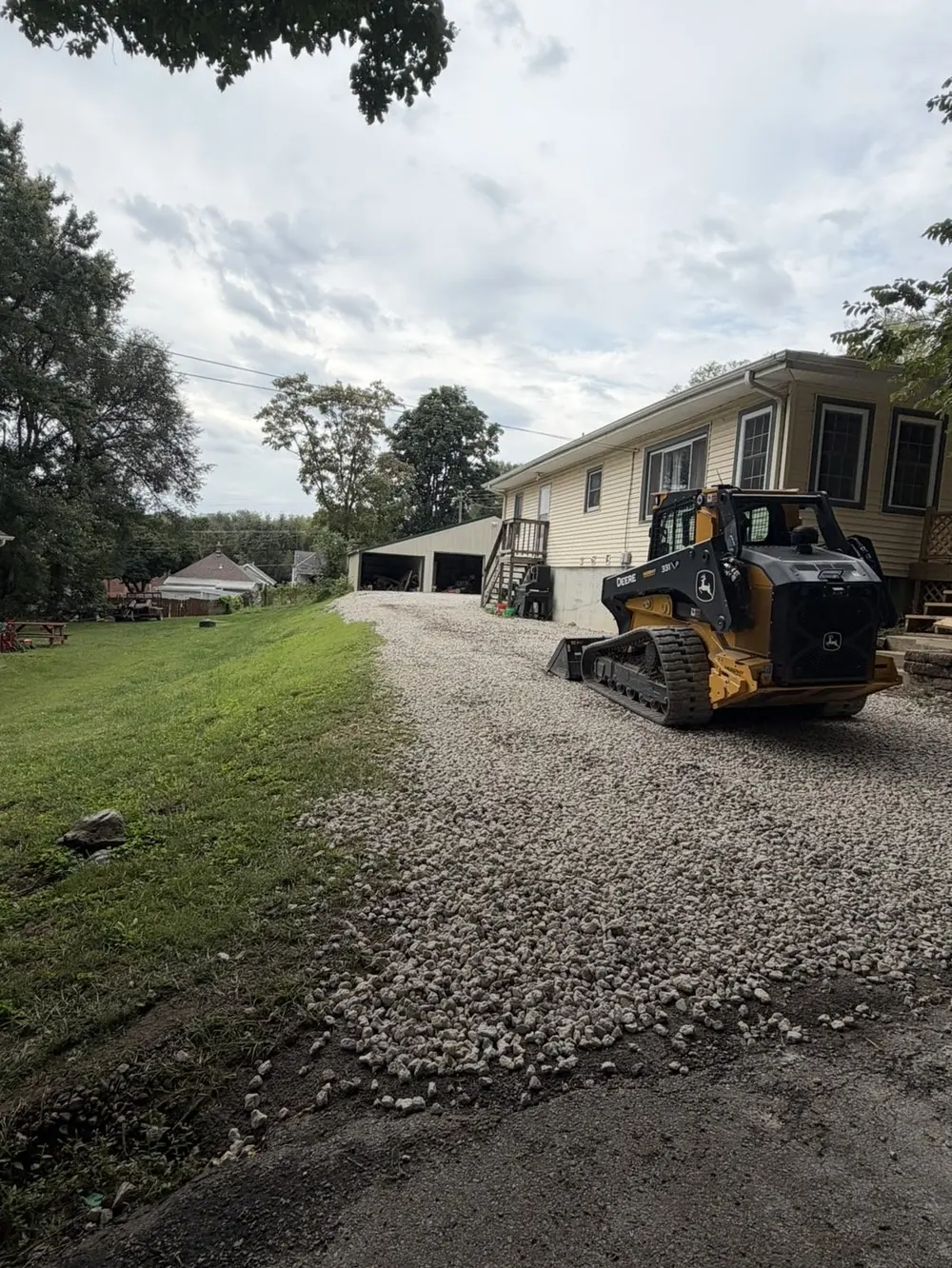 New gravel driveway with a John Deere track loader